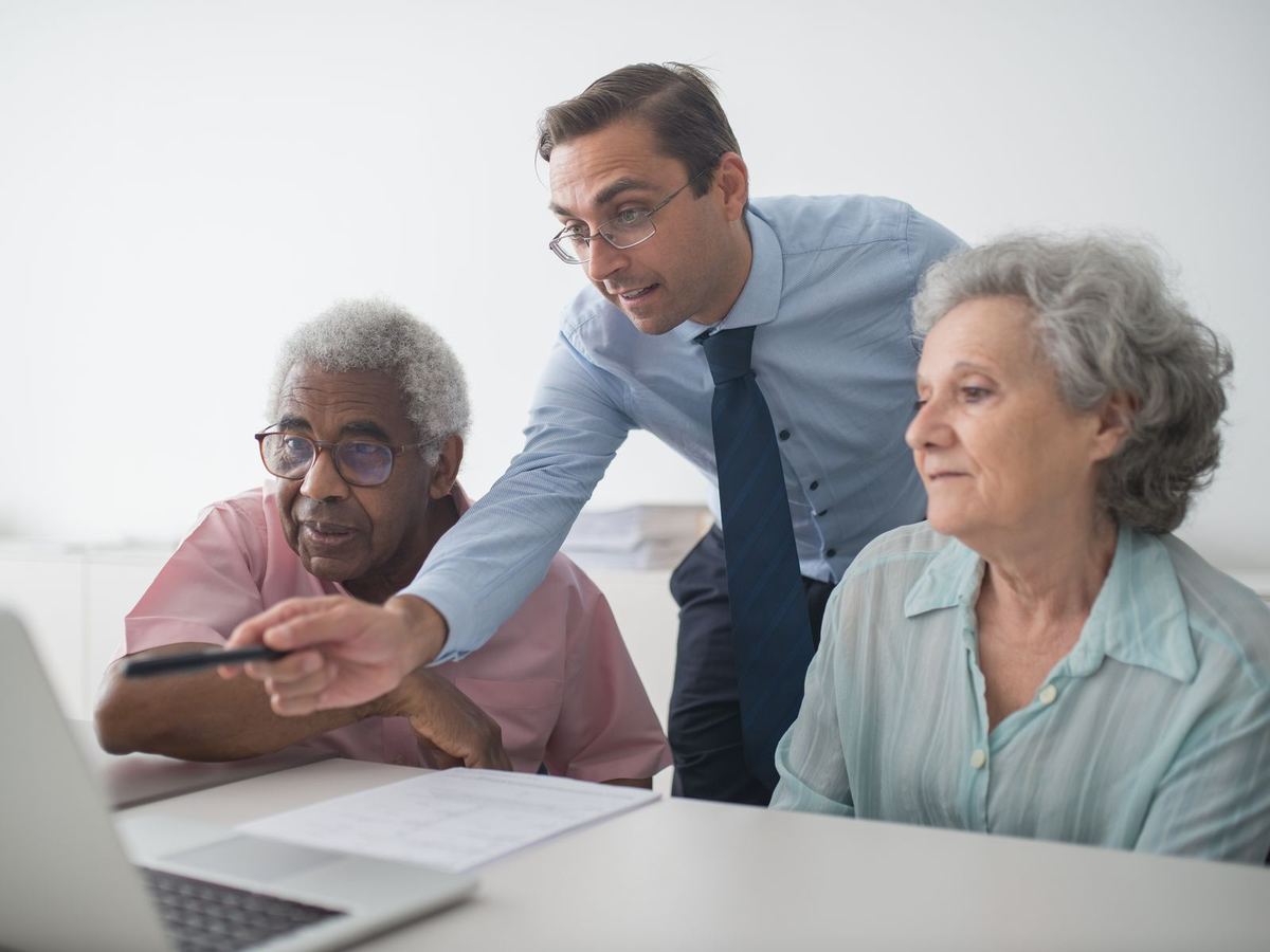 Advisor walking an older couple through their options at a desk
